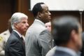 Dr. Conrad Murray stands in court