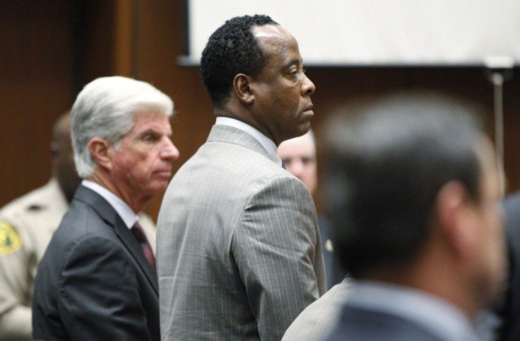 Dr. Conrad Murray stands in court