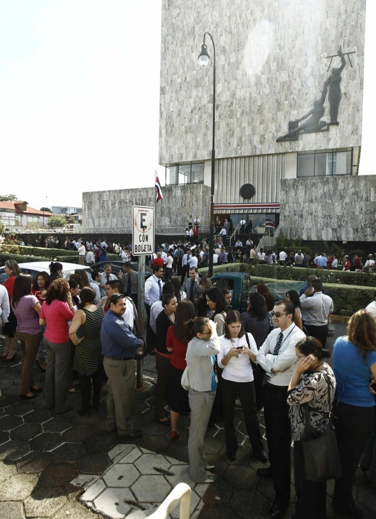 People gather in front of the Supreme Court after being evacuated from their buildings following an earthquake in San Jose