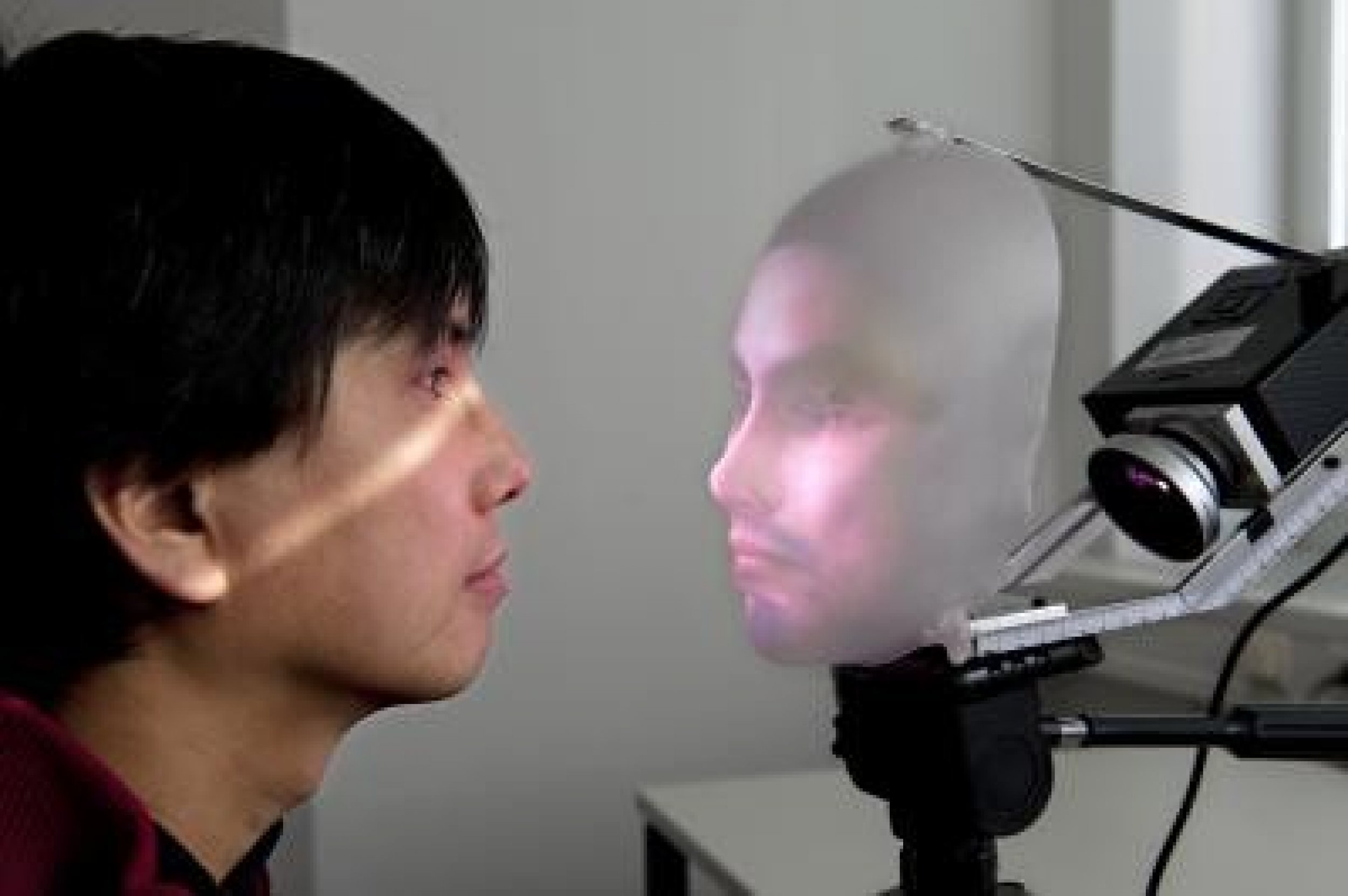 Takaaki Kuratate and his robot communication interface Mask-Bot.