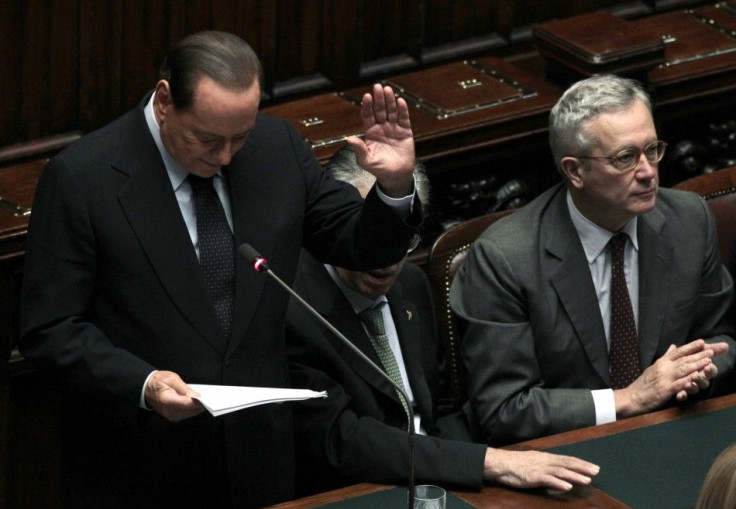 Italy's Prime Minister Silvio Berlusconi gestures as he makes his speech during a debate at the Parliament in Rome