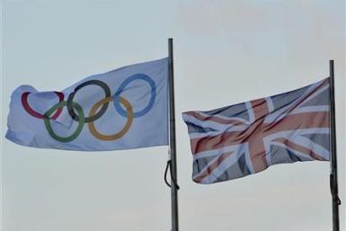 An Olympic flag flies next to the British union flag in central London February 9, 2011.