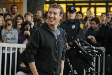 Facebook founder Mark Zuckerberg speaks to a crowd of reporters and students in his first return to Harvard since dropping out in 2004.