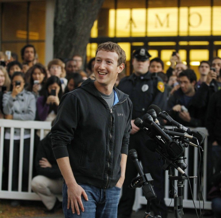 Facebook founder Mark Zuckerberg speaks to a crowd of reporters and students in his first return to Harvard since dropping out in 2004.