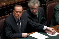 Italian Prime Minister Berlusconi holds League North Party leader Bossi&#039;s hand during a finances vote at the parliament in Rome