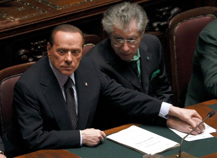 Italian Prime Minister Berlusconi holds League North Party leader Bossi&#039;s hand during a finances vote at the parliament in Rome