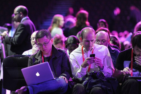 People attending the Nokia World event check their laptops and mobile devices in London