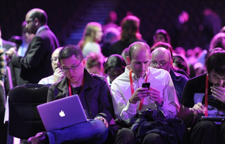 People attending the Nokia World event check their laptops and mobile devices in London