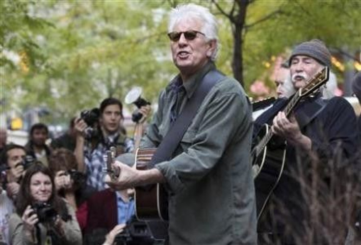 Musicians Graham Nash (2nd R) and David Crosby perform in Zuccotti Park where Occupy Wall Street campaign demonstrators have been occupying in New York November 8, 2011.