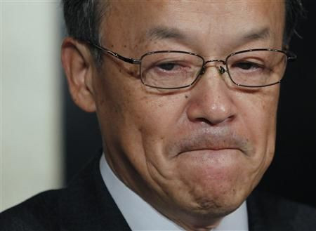 Olympus Corp's President Shuichi Takayama reacts at a news conference in Tokyo