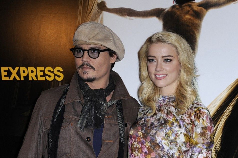 Johnny Depp L and Amber Heard pose for photographers during a photocall for the film quotThe Rum Diaryquot in Paris