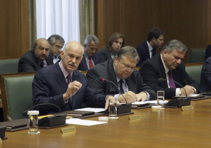 Greece&#039;s PM Papandreou leads a cabinet meeting as Finance Minister Venizelos, Interior Minister Kastanidis and Defence Minister Beglitis keep notes in Athens