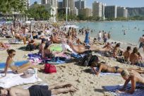 Tourists enjoy the sun on New Year&#039;s Day 2011 on Waikiki Beach in Honolulu, Hawaii.