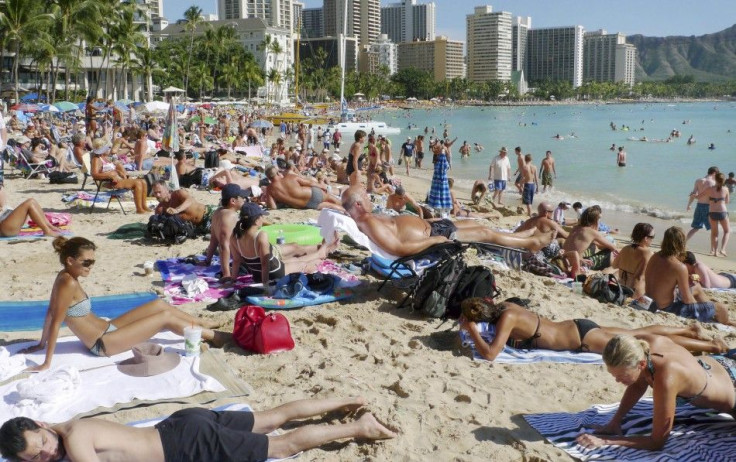 Tourists enjoy the sun on New Year&#039;s Day 2011 on Waikiki Beach in Honolulu, Hawaii.