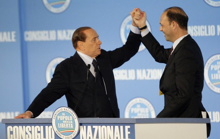 Italy&#039;s PM Berlusconi holds the hand of the former justice minister Alfano after Alfano was elected as new party&#039;s national political secretary during the PDL party national congress in Rome