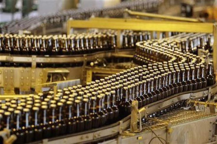 Bottles of beer move along a production line at the South African Brewery in Alrode