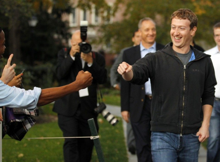 Mark Zuckerberg fist bumps a student at Harvard University in Cambridge
