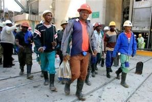 Mine workers emerge from the pithead at the Harmony Gold mine in Carletonville, west of Johannesburg,