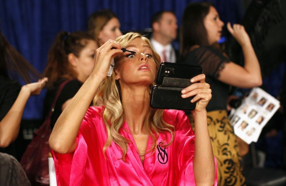 Model Model Erin Heatherton from the U.S. applies eye makeup backstage before the 2011 Victorias Secret Fashion Show in New York