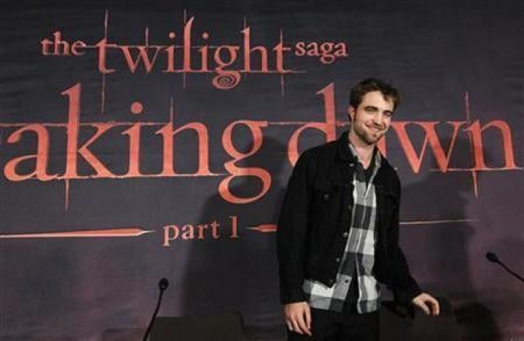 Cast member Robert Pattinson smiles while promoting &#039;&#039;Breaking Dawn&#039;&#039; from the Twilight Saga at the start of a news conference in Brussels