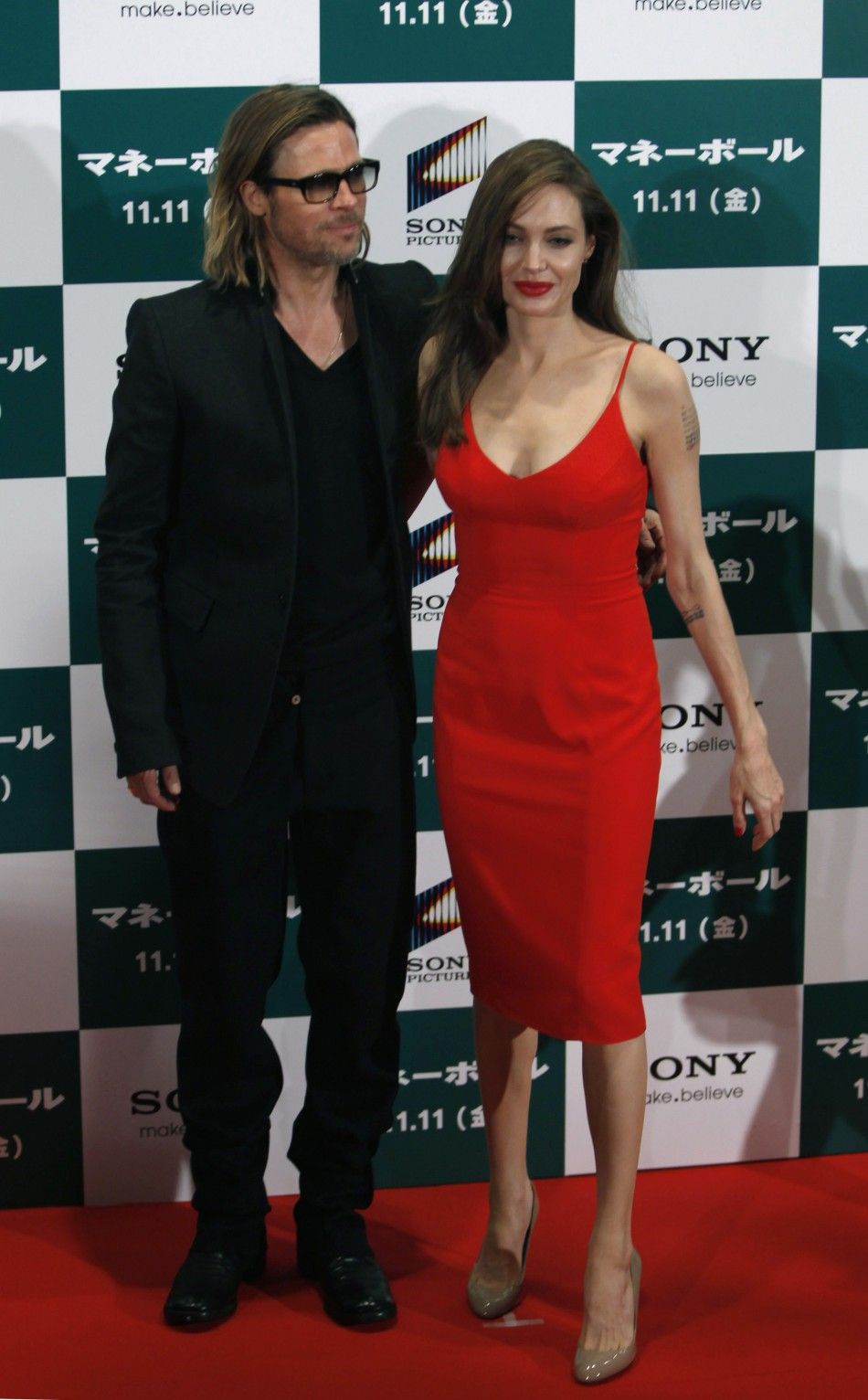 U.S. actor Brad Pitt and his partner Angelina Jolie pose during the Japan premiere of Pitts film quotMoneyballquot in Tokyo