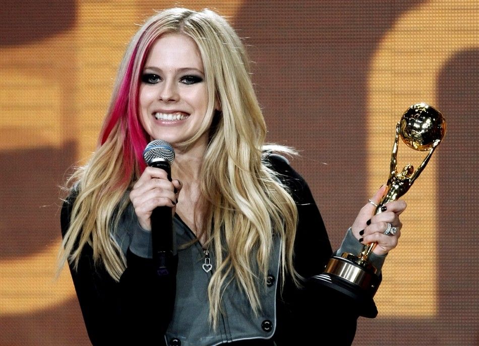 Canadian singer Lavigne holds the Award for the Worlds Best Selling Canadian Artist during the World Music Award in Monte Carlo
