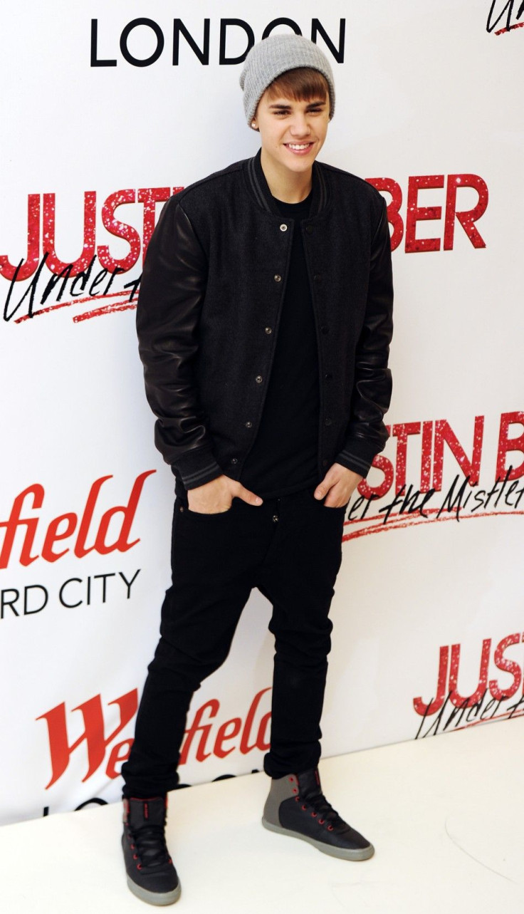 Canadian singer Justin Bieber poses for photographers before switching on the Christmas lights and performing at the Westfield shopping centre in west London