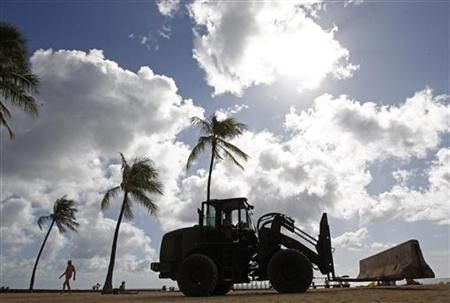 A U.S. Air Force forklift installs concrete barriers along Waikiki Beach before the annual APEC Summit in Honolulu, Hawaii November 9, 2011.