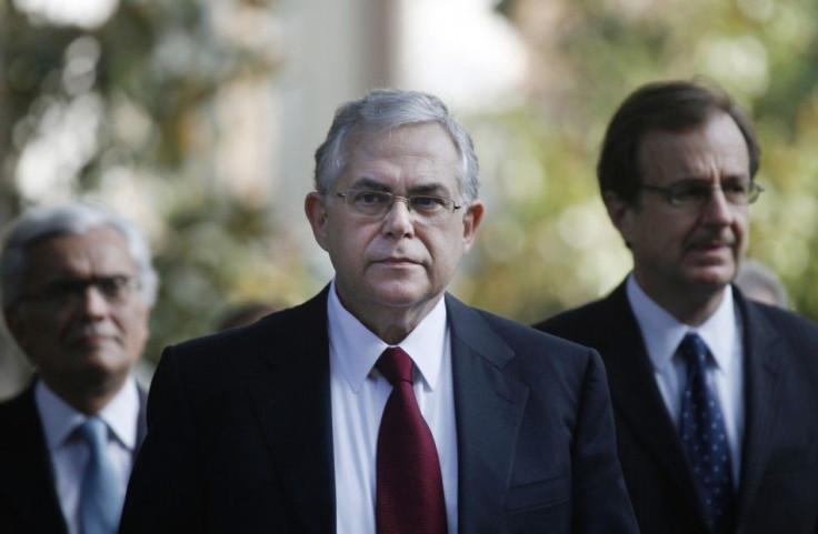 Incoming Prime Minister Lucas Papademos walks through the gardens of the presidential palace after a meeting with Greek political leaders in Athens