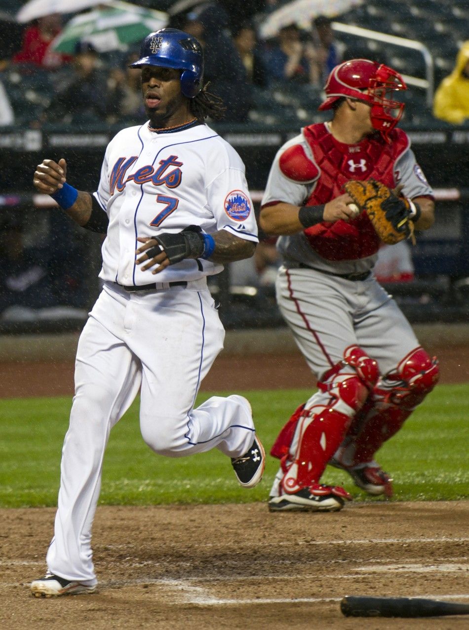 New York Mets runner Reyes passes Washington Nationals catcher Ramos as he scores during their MLB National League baseball game in New York