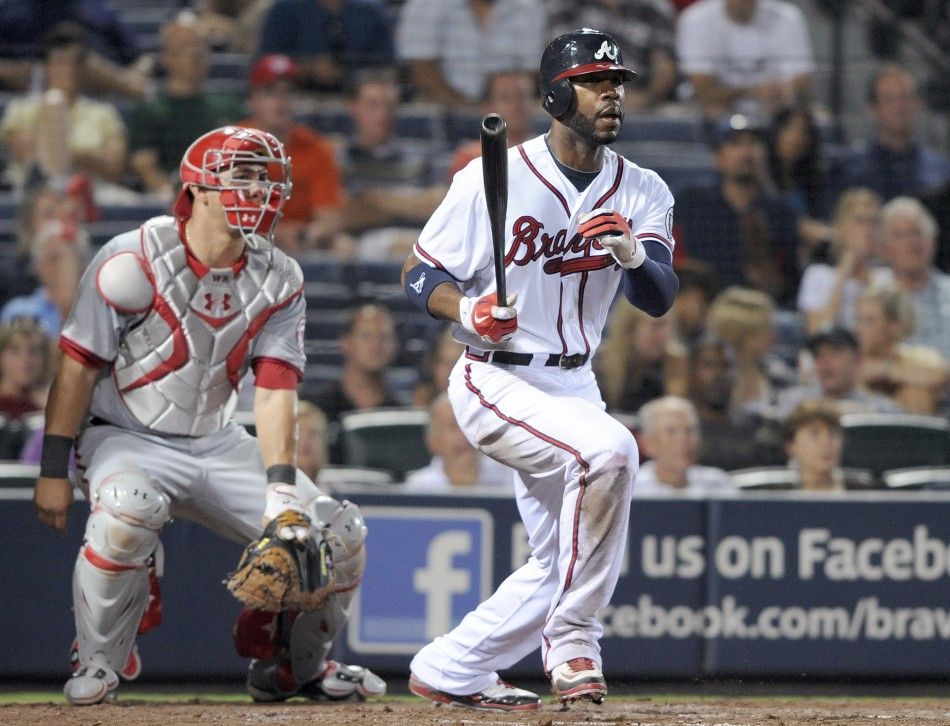 Atlanta Braves right fielder Heyward hits a triple as Washington Nationals catcher Ramos looks on in their MLB game in Atlanta
