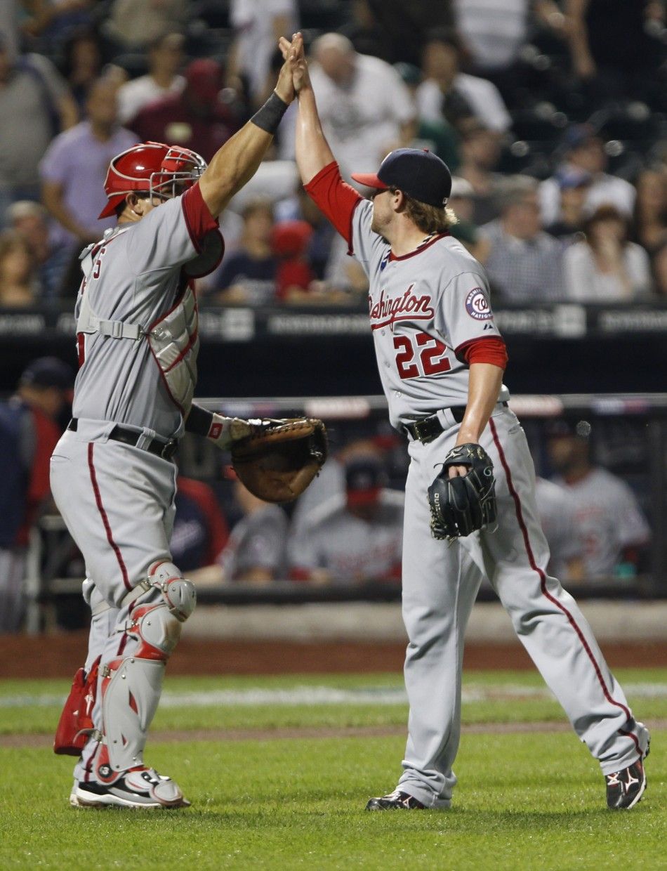 Nationals closing pitcher Storen celebrates with catcher Ramos at the conclusion of their game against Mets in baseball action at Citi Field in New York