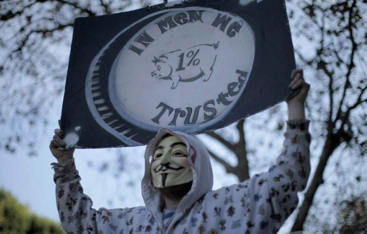 A protester holds up a sign during an Occupy LA march in Los Angeles, California