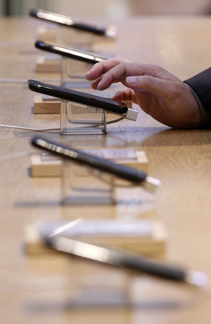 A customer touches Samsung Electronics' Galaxy S II smartphone on display at a shop at the company's headquarters in Seoul