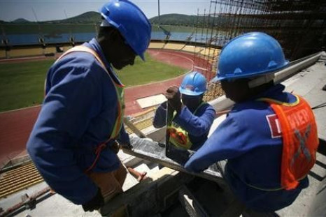 Workers cut wood during the modernisation work at the Royal Bafokeng Stadium in Rustenberg