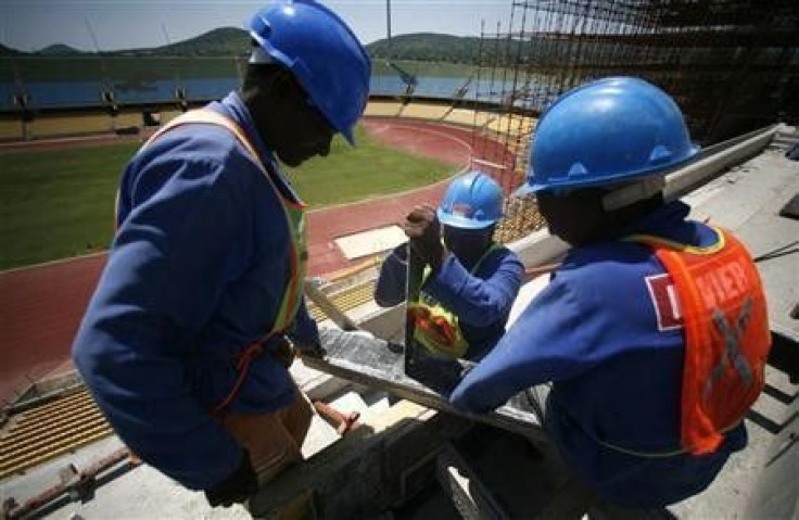 Workers cut wood during the modernisation work at the Royal Bafokeng Stadium in Rustenberg