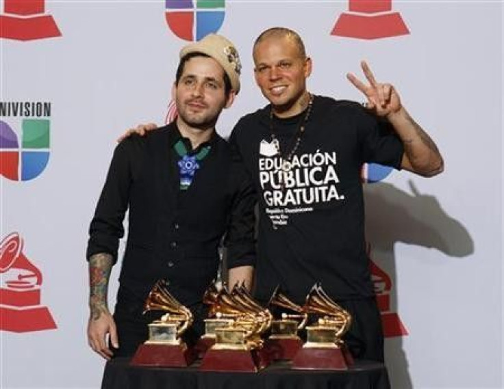 Visitante (L) and Residente of Calle 13 pose backstage with the eight awards they won at the 12th annual Latin Grammy Awards in Las Vegas, Nevada