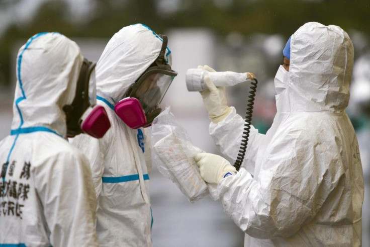 Man is checked for radiation after arriving at vehicle decontamination centre at J-Village, soccer training complex now serving as operation base, near TEPCO's Fukushima Daiichi Nuclear Power Plant