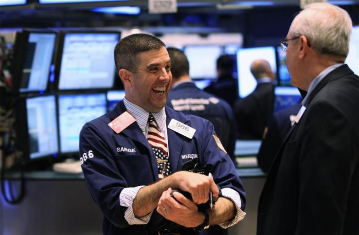 A trader smiles as he works on the floor of the New York Stock Exchange after the closing bell in New York