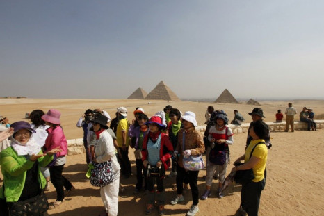 Asian tourists Visit the Sphinx and the Pyramids of Giza in Cairo, on October 19, 2011.