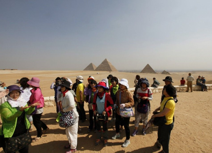 Asian tourists Visit the Sphinx and the Pyramids of Giza in Cairo, on October 19, 2011.