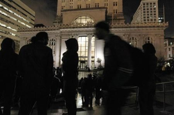 People walk around an Occupy Oakland encampment in front of City Hall in Oakland, California