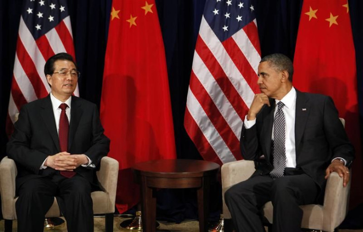 U.S. President Obama listens to Chinese President Hu Jintao during APEC Summit in Hawaii