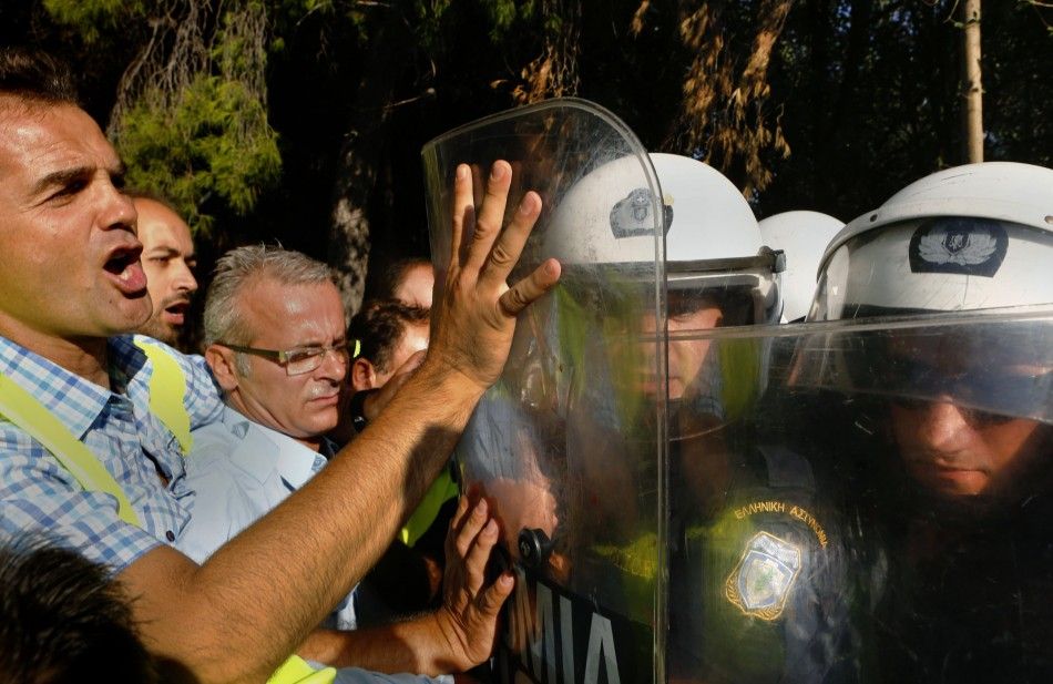 On-duty Greek riot police clashed with a small contingent of colleagues on strike Thursday, in an event that put an emotional climax to a week of protest in Greece.