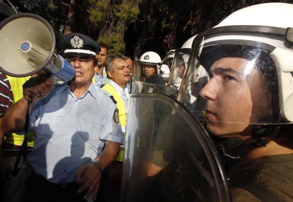 On-duty Greek riot police clashed with a small contingent of colleagues on strike Thursday, in an event that put an emotional climax to a week of protest in Greece.
