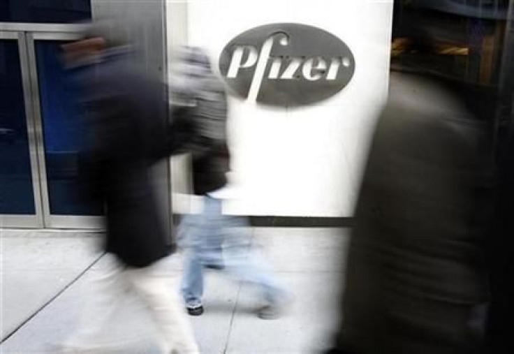 People walk past the Pfizer World headquarters in New York