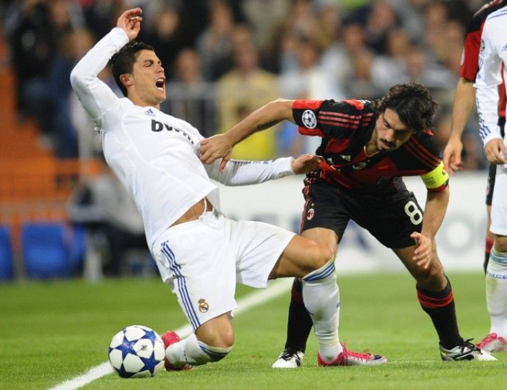  Real Madrid's Ronaldo is tackled by AC Milan's Gattuso during their Champions League Group G soccer match in Madrid.
