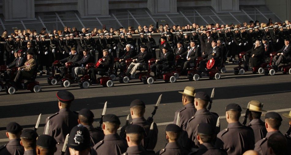 War veterans ride mobility scooters past the Cenotaph during the annual Remembrance Sunday ceremony in London November 13, 2011. 
