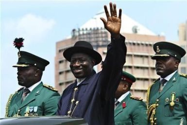 Nigeria's President Goodluck Jonathan waves during a military parade marking Nigeria's 50th independence anniversary in Abuja 