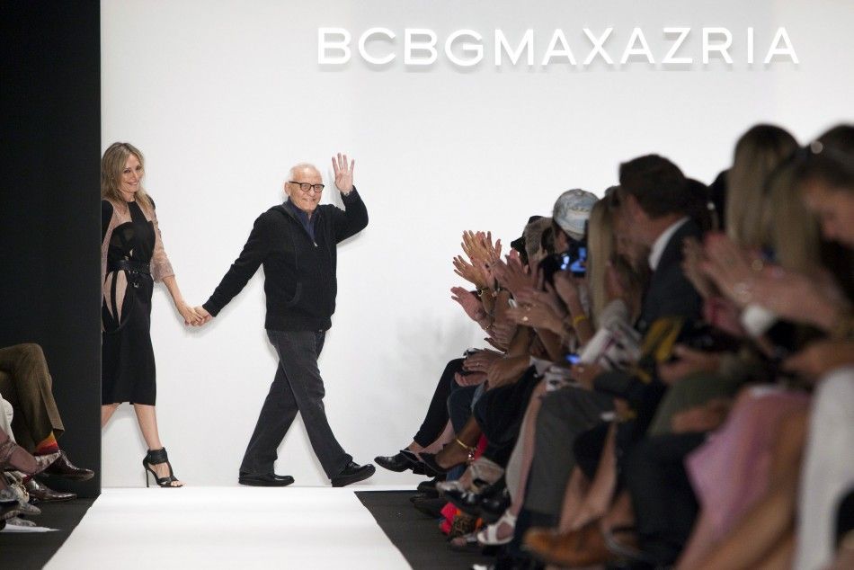 Designer Max Azria waves to the crowd after the presentation of the BCBGMAXAZRIA SpringSummer 2013 collection during New York Fashion Week, September 6, 2012. 